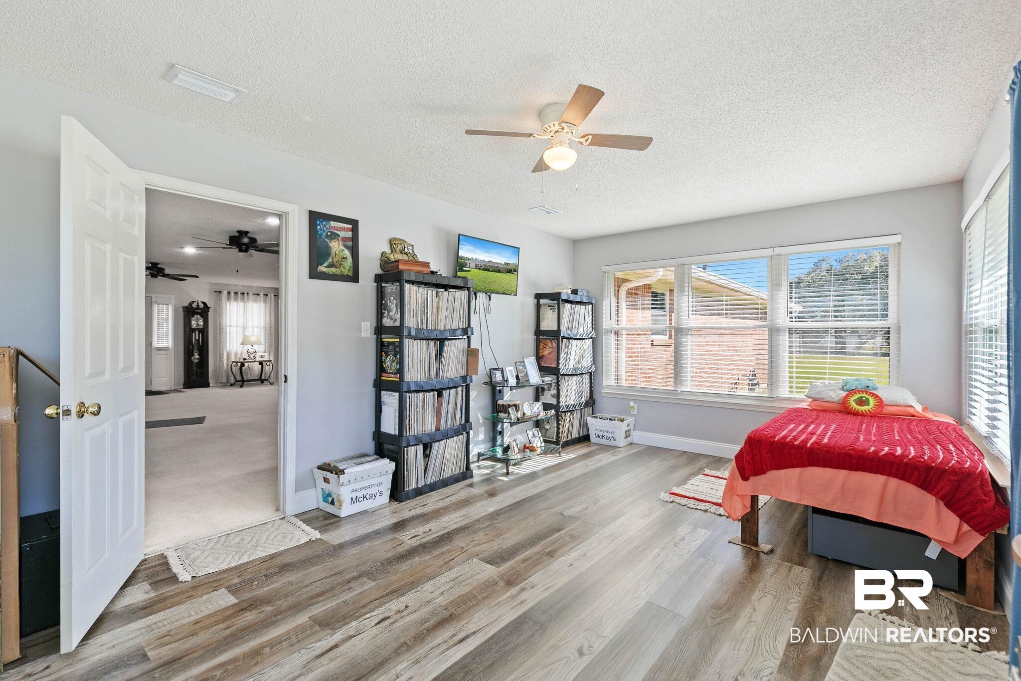 1510 South Juniper Street Foley, AL 36535 - Photo 26 of 36 Bedroom with a textured ceiling, ceiling fan, and wood finished floors