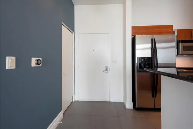 a view of kitchen with a refrigerator and a window