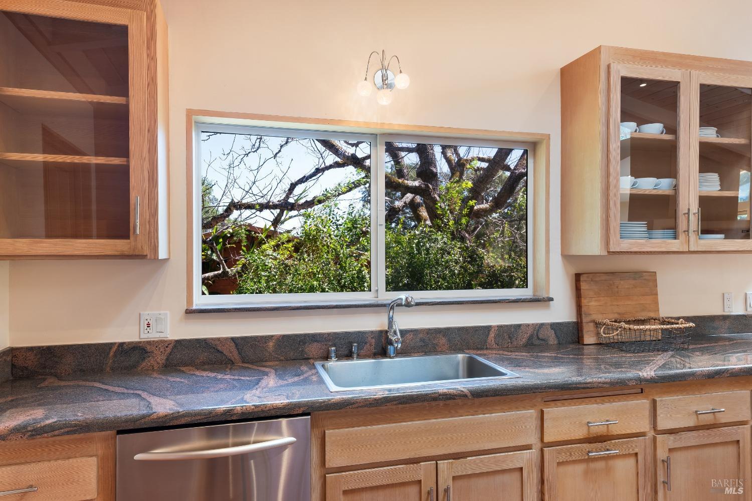 321 Dutch Henry Canyon Road Calistoga, CA 94515 - Photo 13 of 45 a kitchen with granite countertop a sink window and cabinets