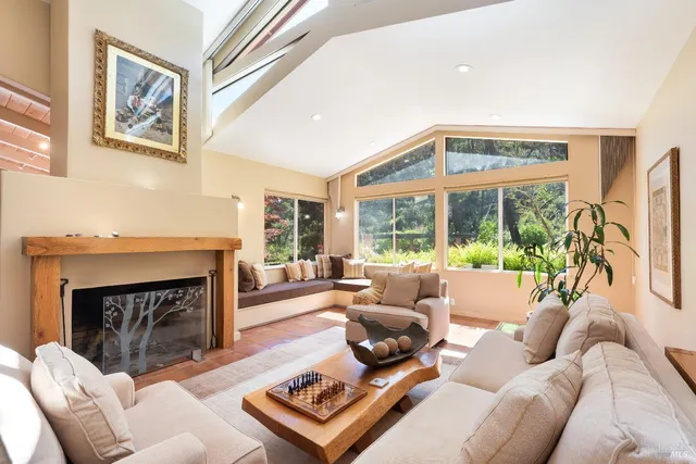 a living room with furniture large window and a fireplace