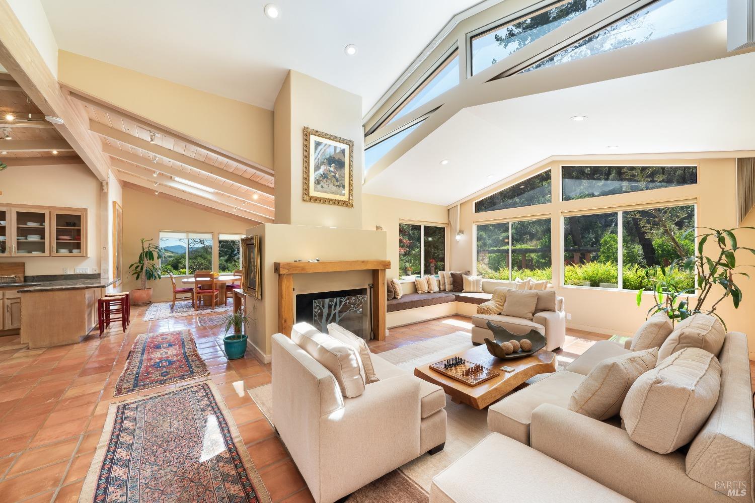 321 Dutch Henry Canyon Road Calistoga, CA 94515 - Photo 17 of 45 a living room with furniture large window and a fireplace
