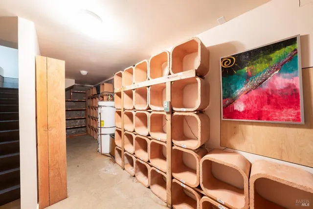a view of a patio with lawn chairs under an umbrella