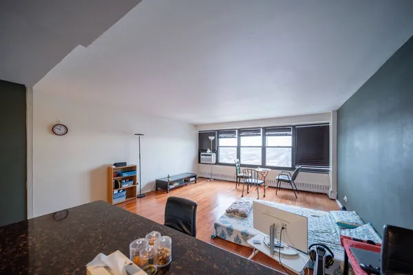 a kitchen with stainless steel appliances granite countertop a refrigerator a stove and a sink with wooden cabinets