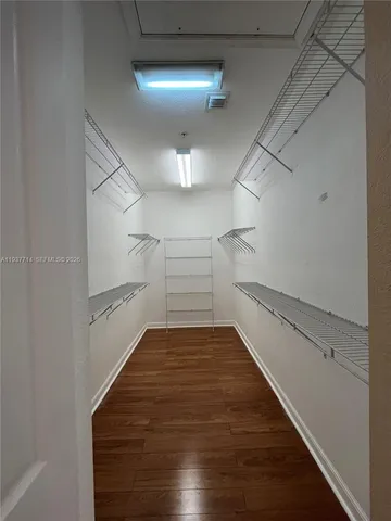 a view of a room with wooden floor