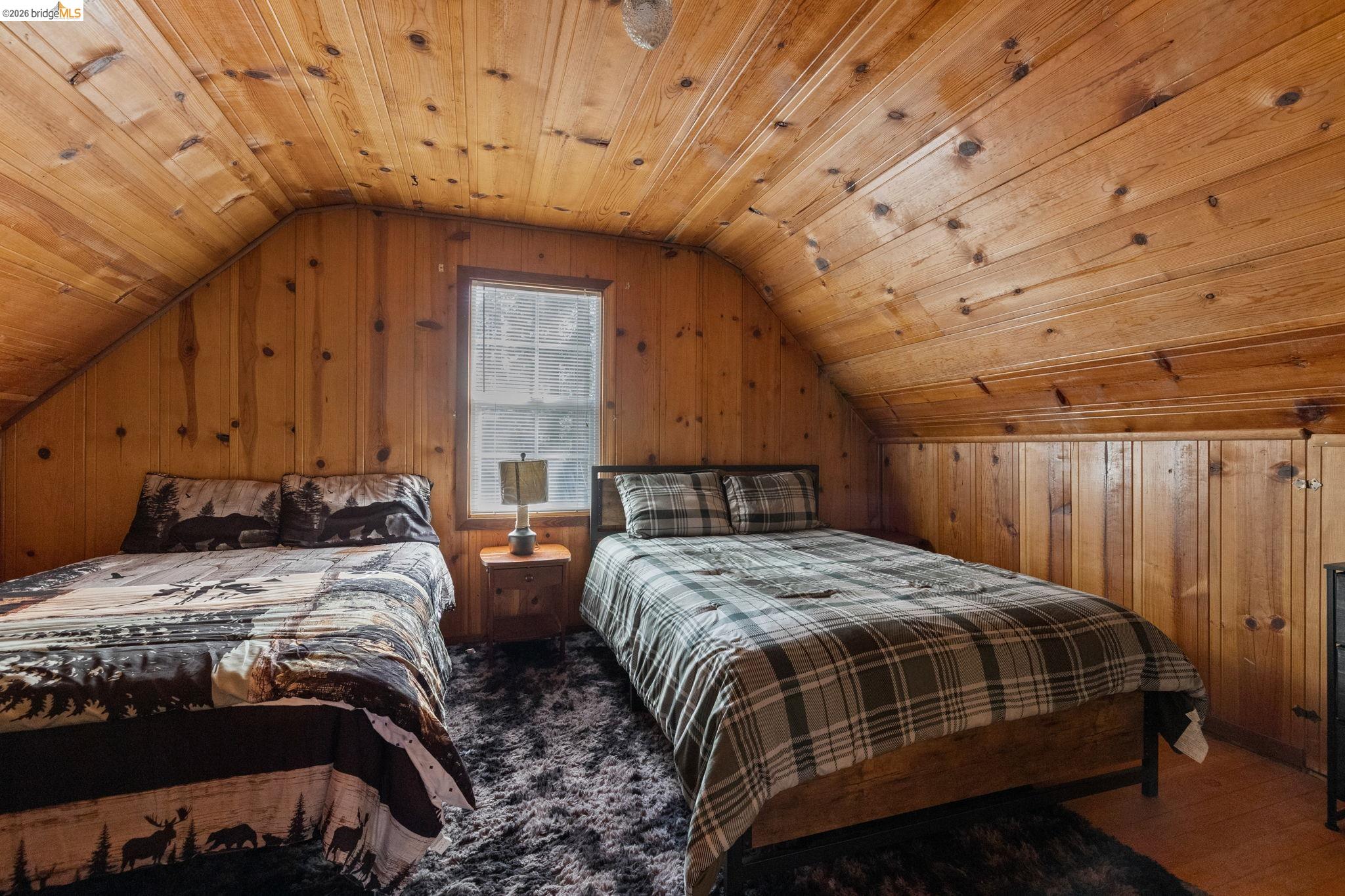 26175 Janice Way Long Barn, CA 95335 - Photo 16 of 23 Bedroom featuring wood walls and a vaulted wooden ceiling