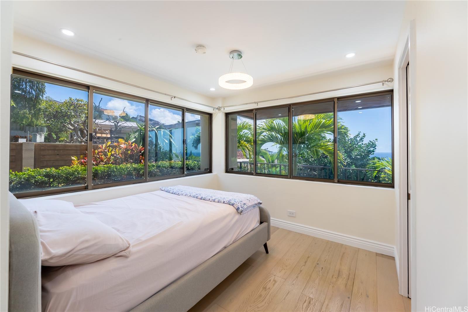 1632 Ihiloa Loop Honolulu, HI 96821 - Photo 18 of 24 a bed sitting in a bedroom next to a large window