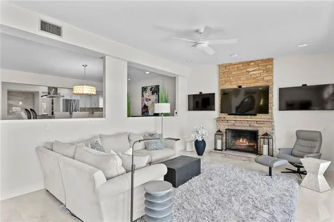 a living room with furniture flat screen tv and a fireplace