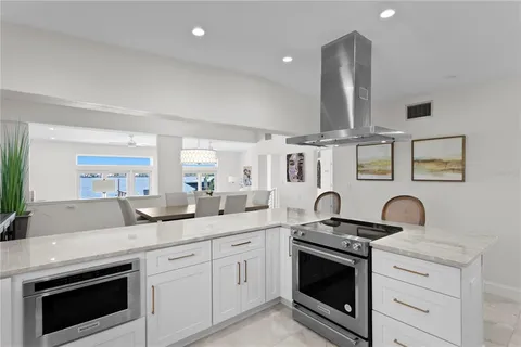 a kitchen with stainless steel appliances granite countertop a sink stove and cabinets