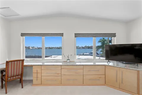 a bathroom with a granite countertop sink mirror vanity and toilet