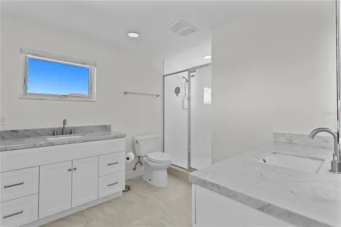 a bathroom with a granite countertop sink vanity and mirror