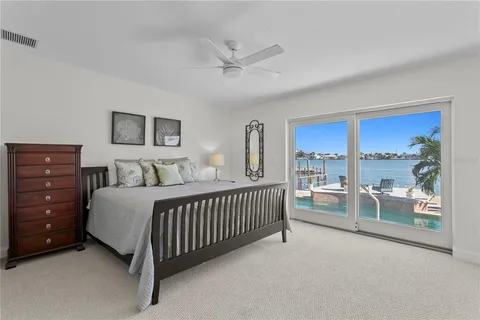 a view of a hallway with wooden floor and chandelier