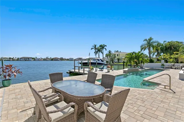 a view of a house with backyard and sitting area