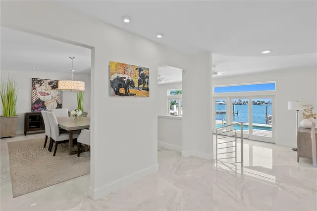 a living room with furniture a dining table and a refrigerator