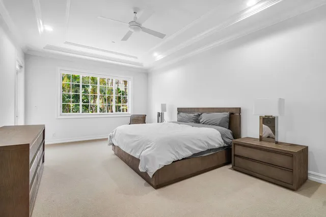 a spacious bathroom with a double vanity sink a large mirror and a bathtub