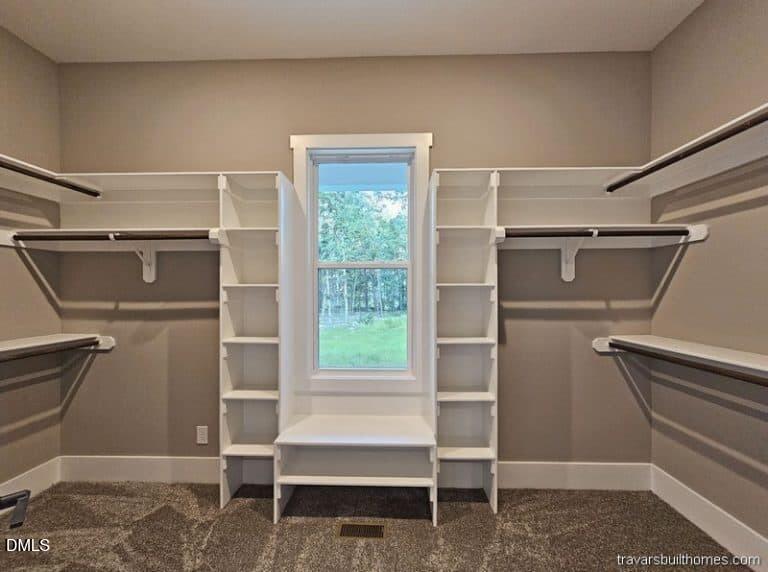 5491 Silk Hope Gum Spring Road Siler City, NC 27344 - Photo 14 of 17 a view of walk in closet with empty racks