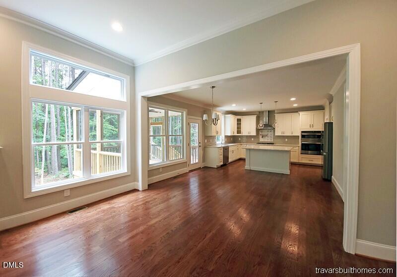 5491 Silk Hope Gum Spring Road Siler City, NC 27344 - Photo 3 of 17 a view of a living room a kitchen with furniture and large windows