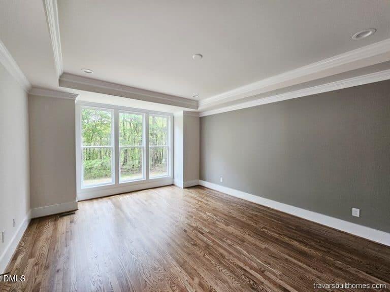 5491 Silk Hope Gum Spring Road Siler City, NC 27344 - Photo 10 of 17 a view of an empty room with wooden floor and a window