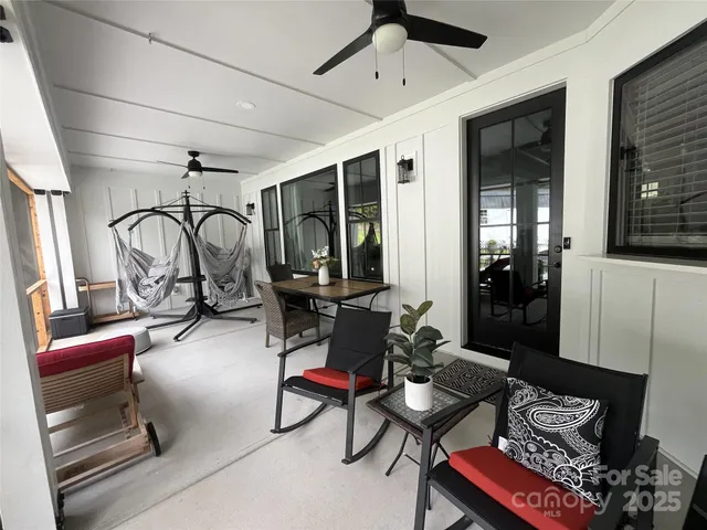 a living room with patio furniture and a flat screen tv