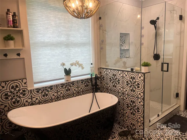 a bathroom with a bathtub and shower