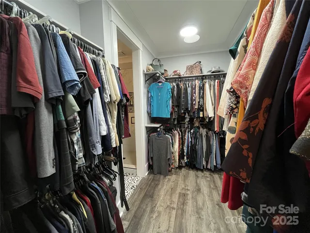 a view of walk in closet with clothes