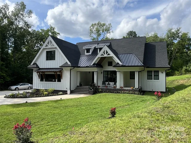 a front view of a house with sitting area and garden