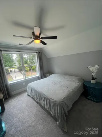 a bed sitting in a bedroom next to a window