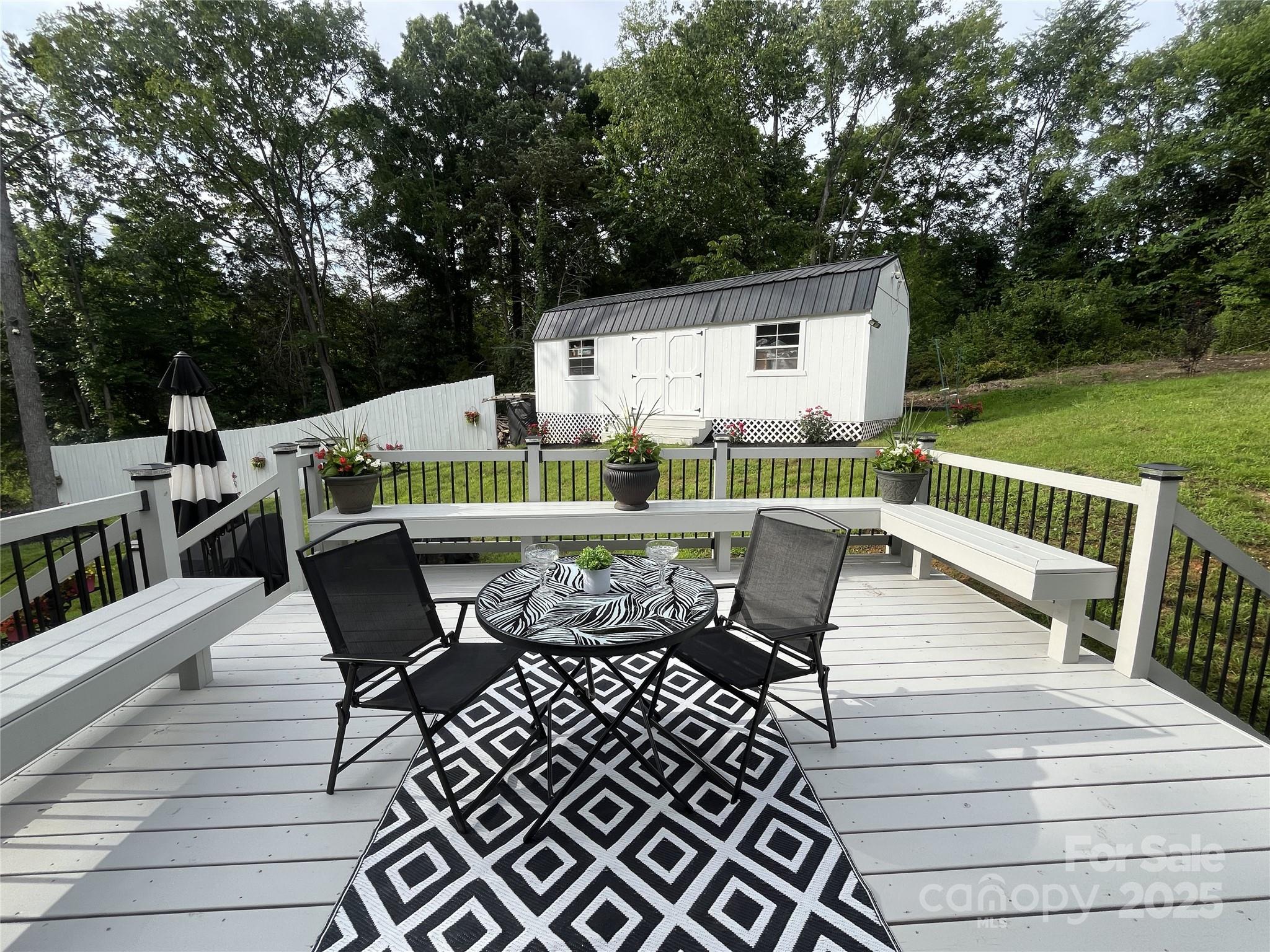 900 Houston Heights Road Charlotte, NC 28262 - Photo 39 of 44 a roof deck with table and chairs and wooden floor