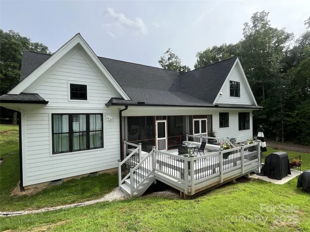 a view of a house with a bed and chairs
