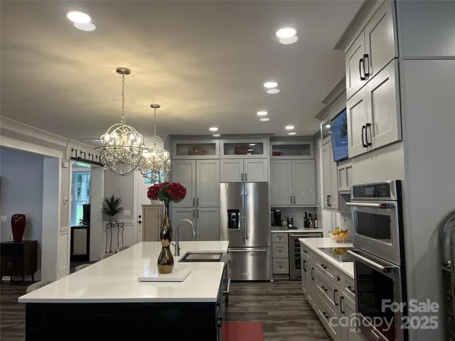 a kitchen with refrigerator and cabinets