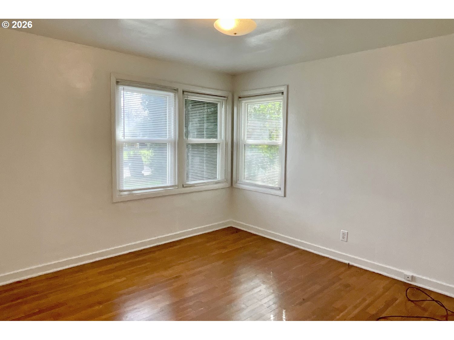 480 Gilbert Street Eugene, OR 97402 - Photo 16 of 33 an empty room with wooden floor and windows