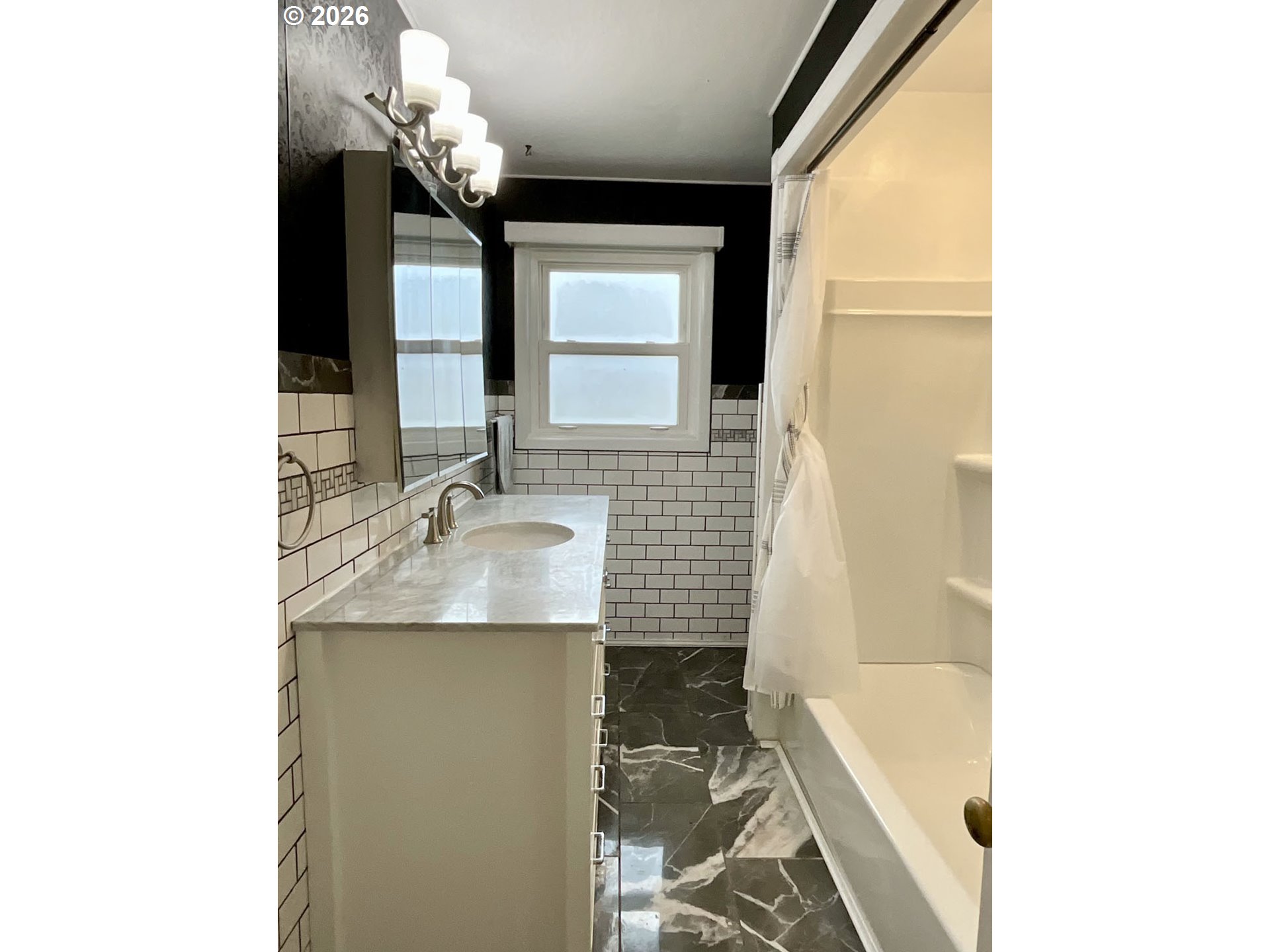 480 Gilbert Street Eugene, OR 97402 - Photo 18 of 33 a bathroom with a sink a mirror and a bathtub