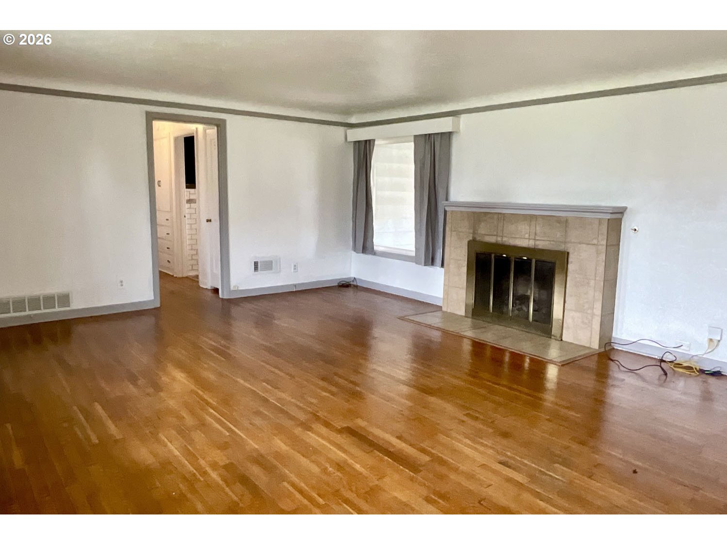 480 Gilbert Street Eugene, OR 97402 - Photo 3 of 33 a view of empty room with wooden floor and fireplace