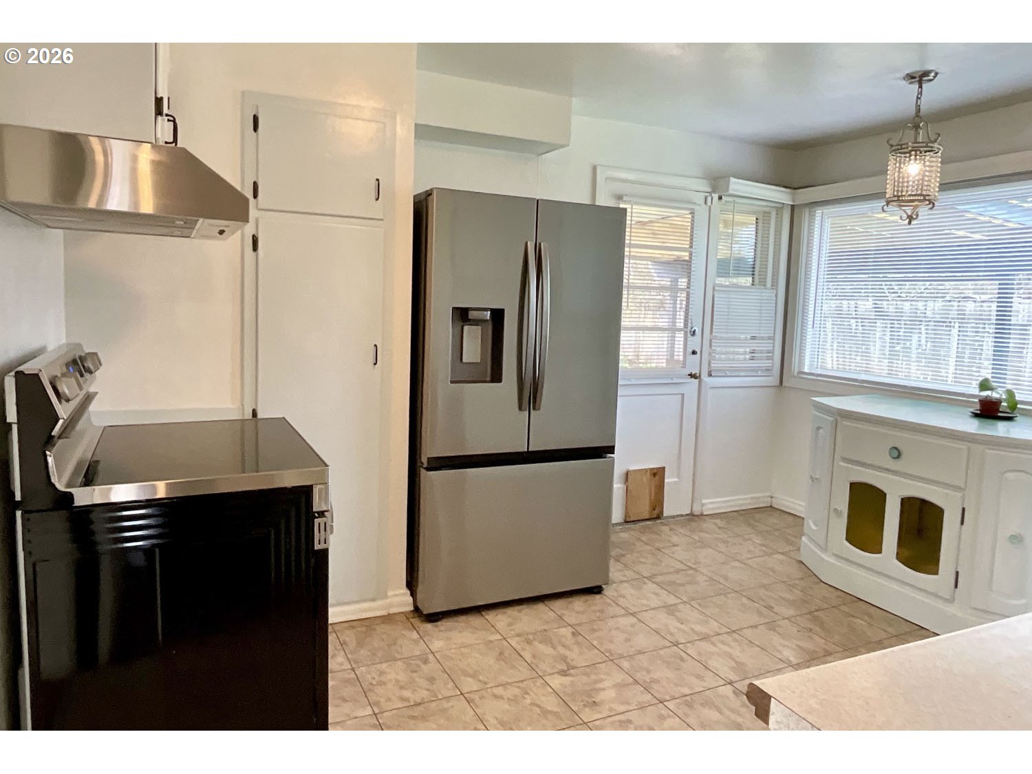 480 Gilbert Street Eugene, OR 97402 - Photo 10 of 33 a kitchen with stainless steel appliances granite countertop a refrigerator a stove and a sink with wooden floors