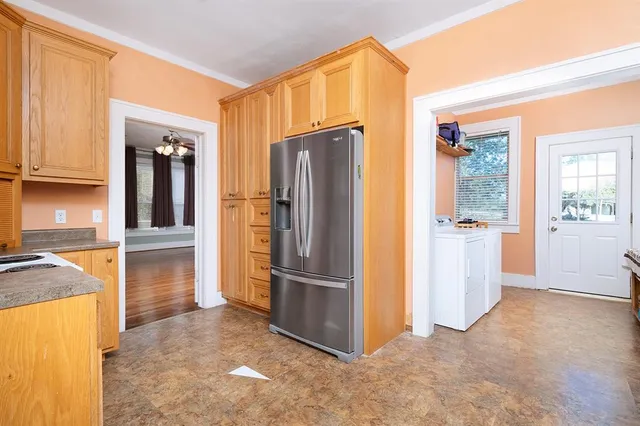 a view of a kitchen with refrigerator and cabinet