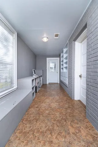 a view of a hallway with windows