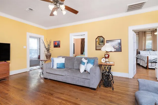 a living room with furniture and a wooden floor