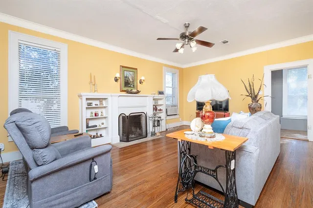 a living room with furniture a fireplace and a chandelier