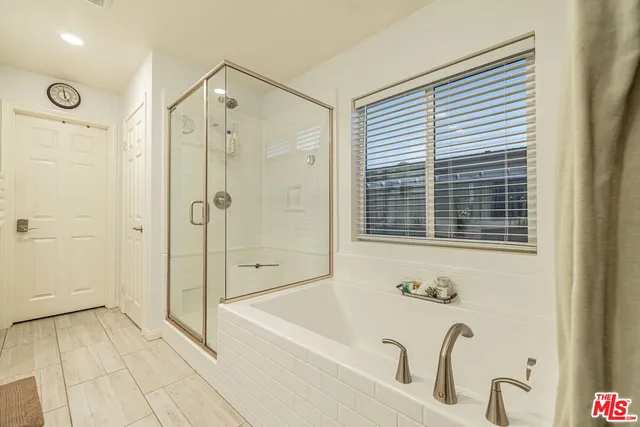 a bathroom with a bathtub and a shower