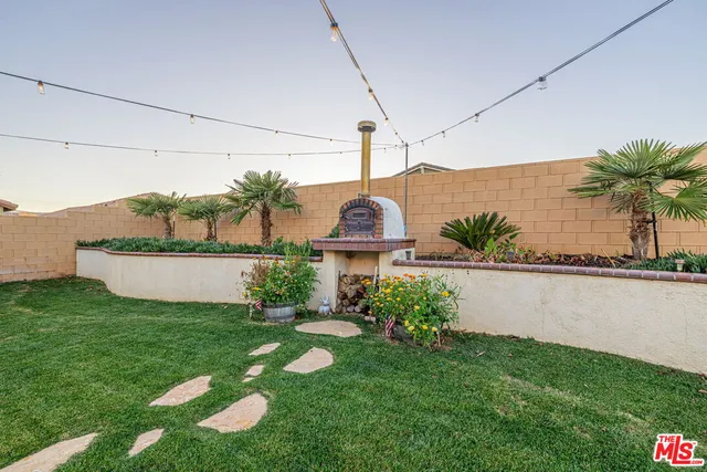 a view of a house with a big yard and potted plants