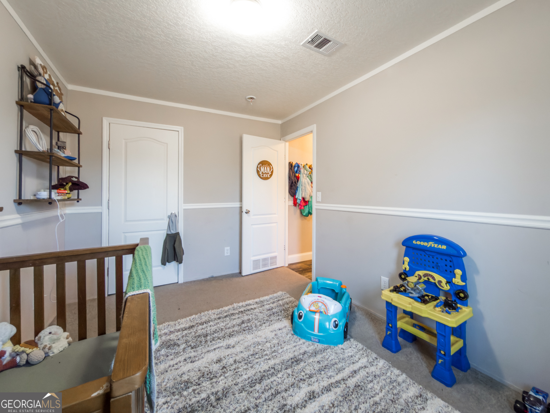 12546 Highway 1 Wrens, GA 30833 - Photo 31 of 41 a bedroom with baby toys and wooden floor