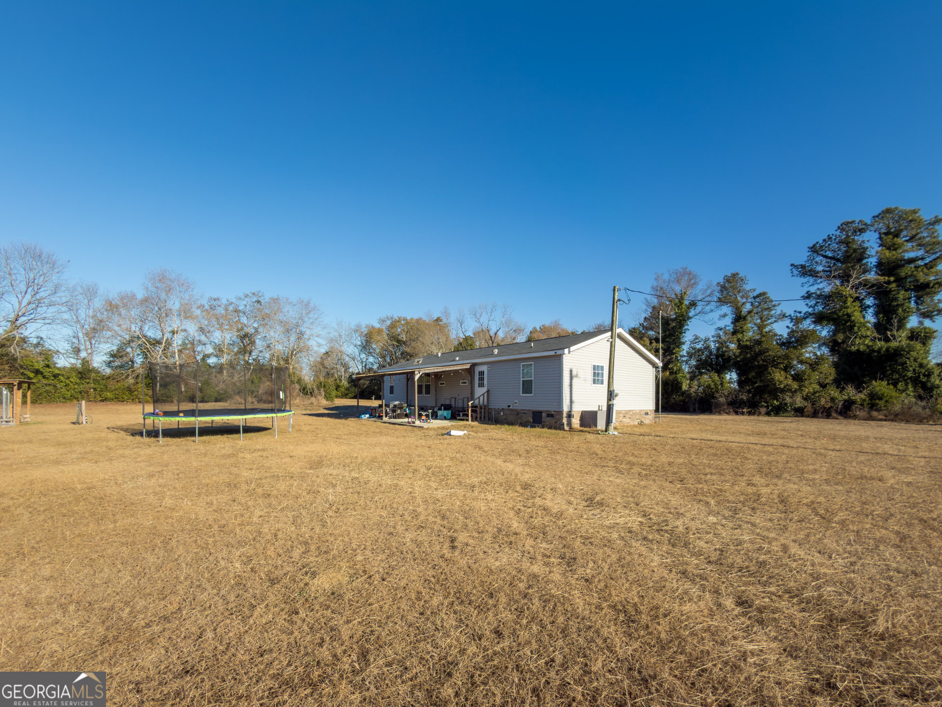 12546 Highway 1 Wrens, GA 30833 - Photo 38 of 41 a large house with a beach