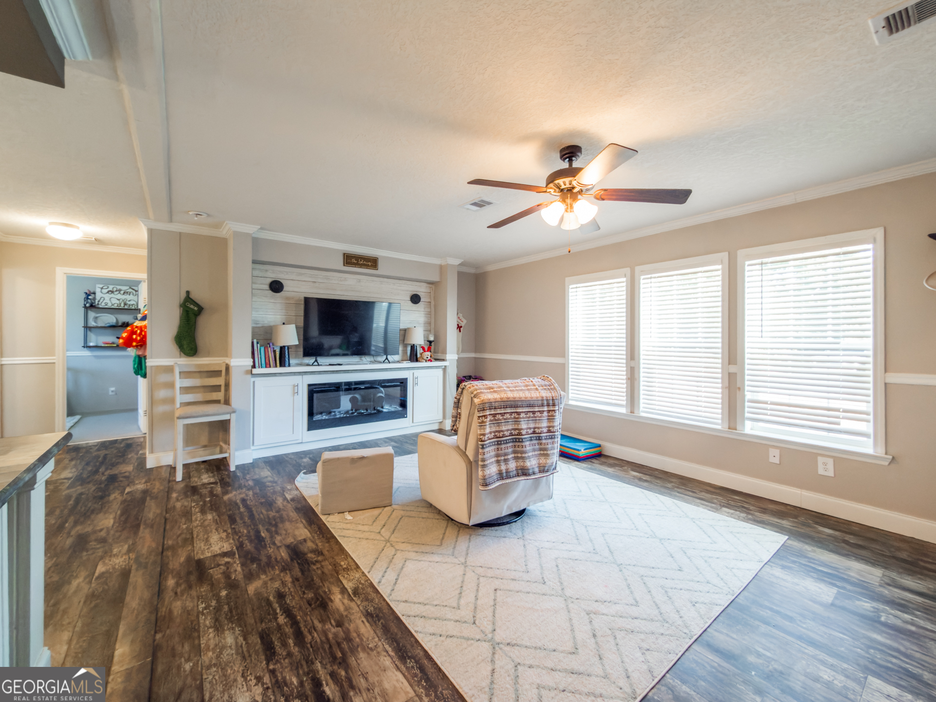 12546 Highway 1 Wrens, GA 30833 - Photo 10 of 41 a living room with furniture and a flat screen tv