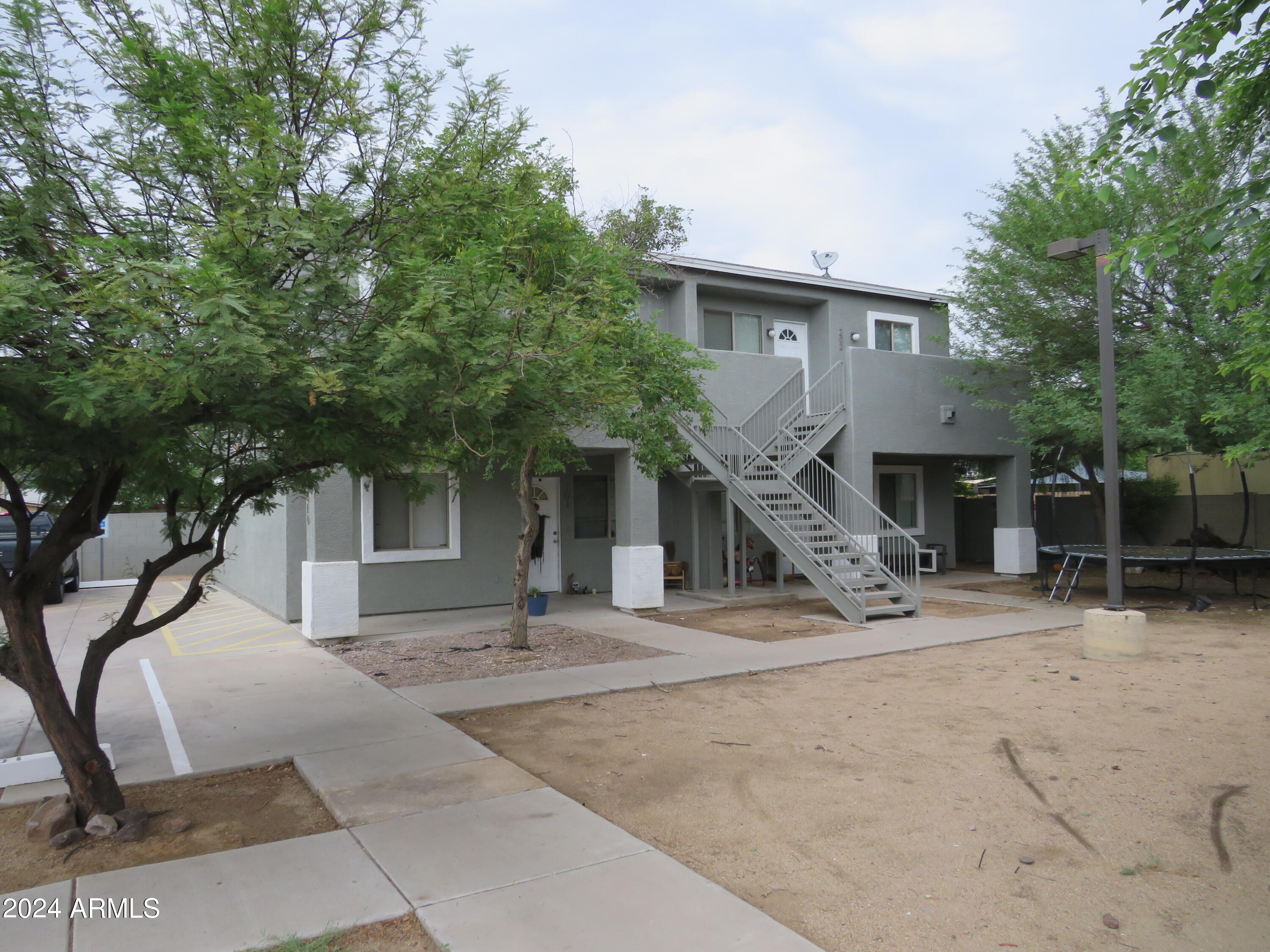 1614 West Purdue Avenue, Unit 202 Phoenix, AZ 85021 - Photo 1 of 8 a front view of a house with garage
