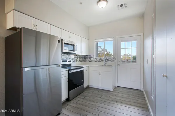 a kitchen with a refrigerator stove and sink