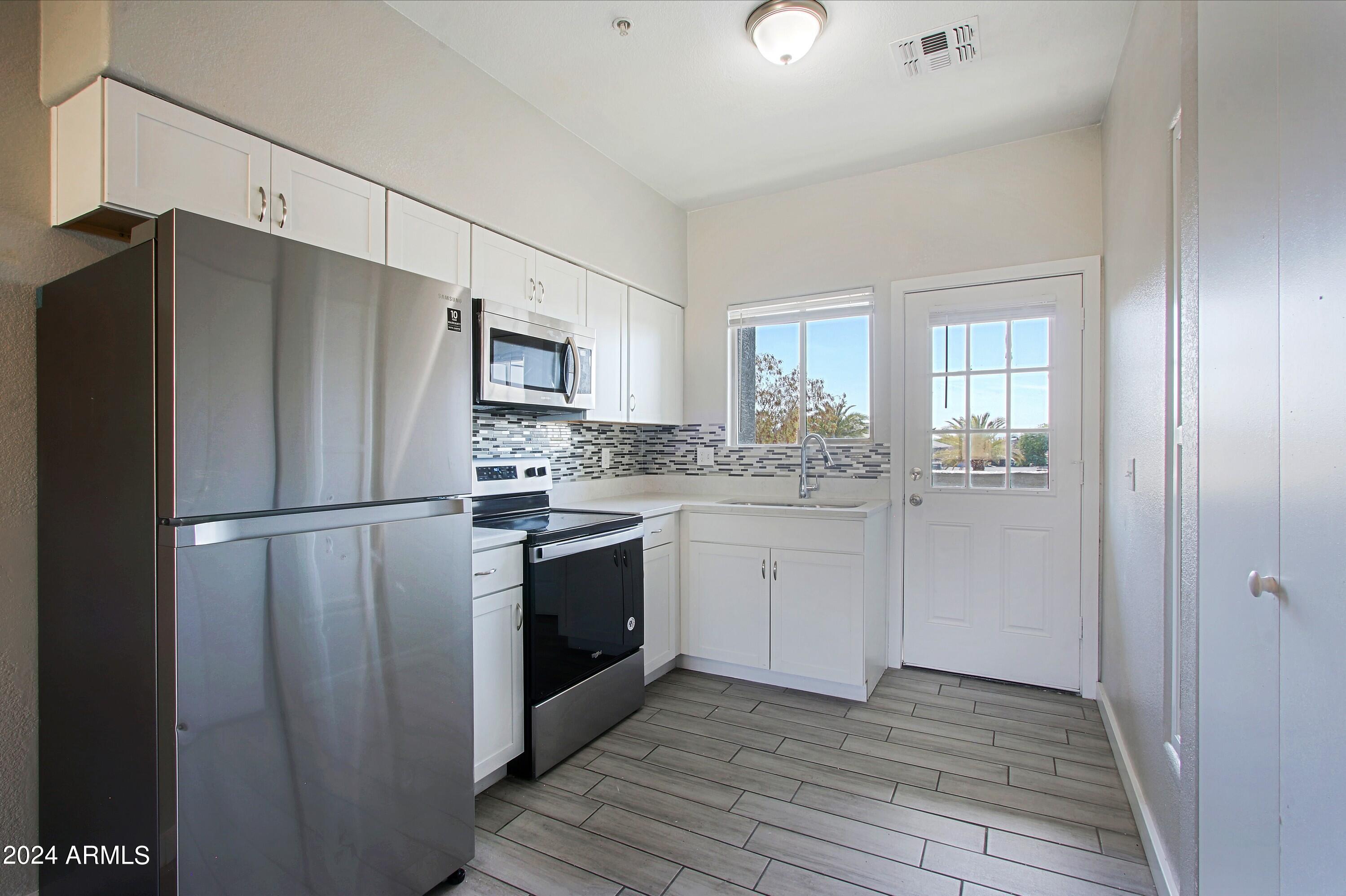 1614 West Purdue Avenue, Unit 202 Phoenix, AZ 85021 - Photo 3 of 8 a kitchen with a refrigerator stove and sink