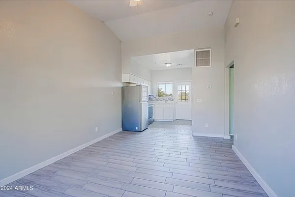 a view of empty room with wooden floor