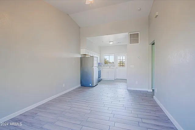 a view of empty room with wooden floor
