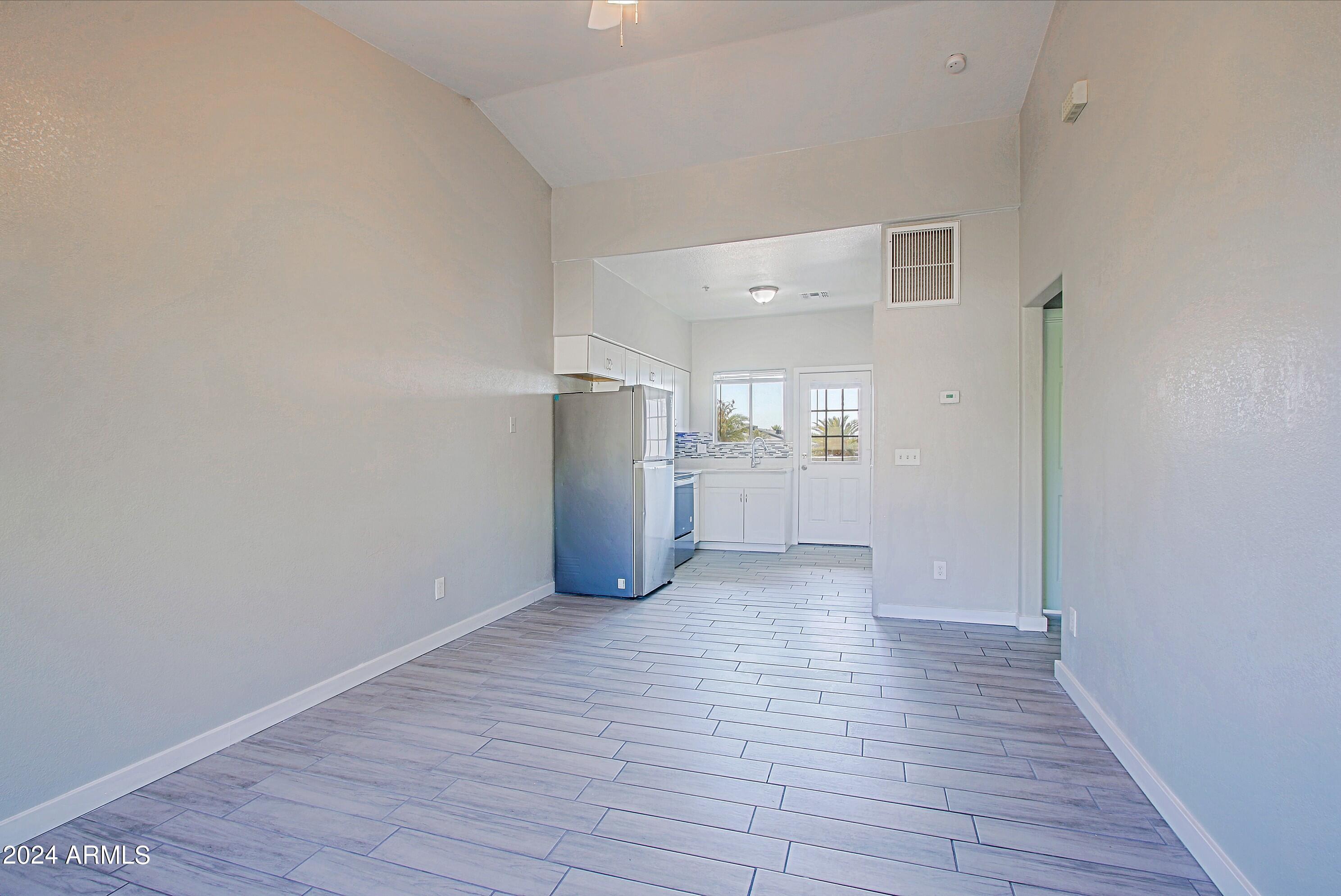 1614 West Purdue Avenue, Unit 202 Phoenix, AZ 85021 - Photo 4 of 8 a view of empty room with wooden floor