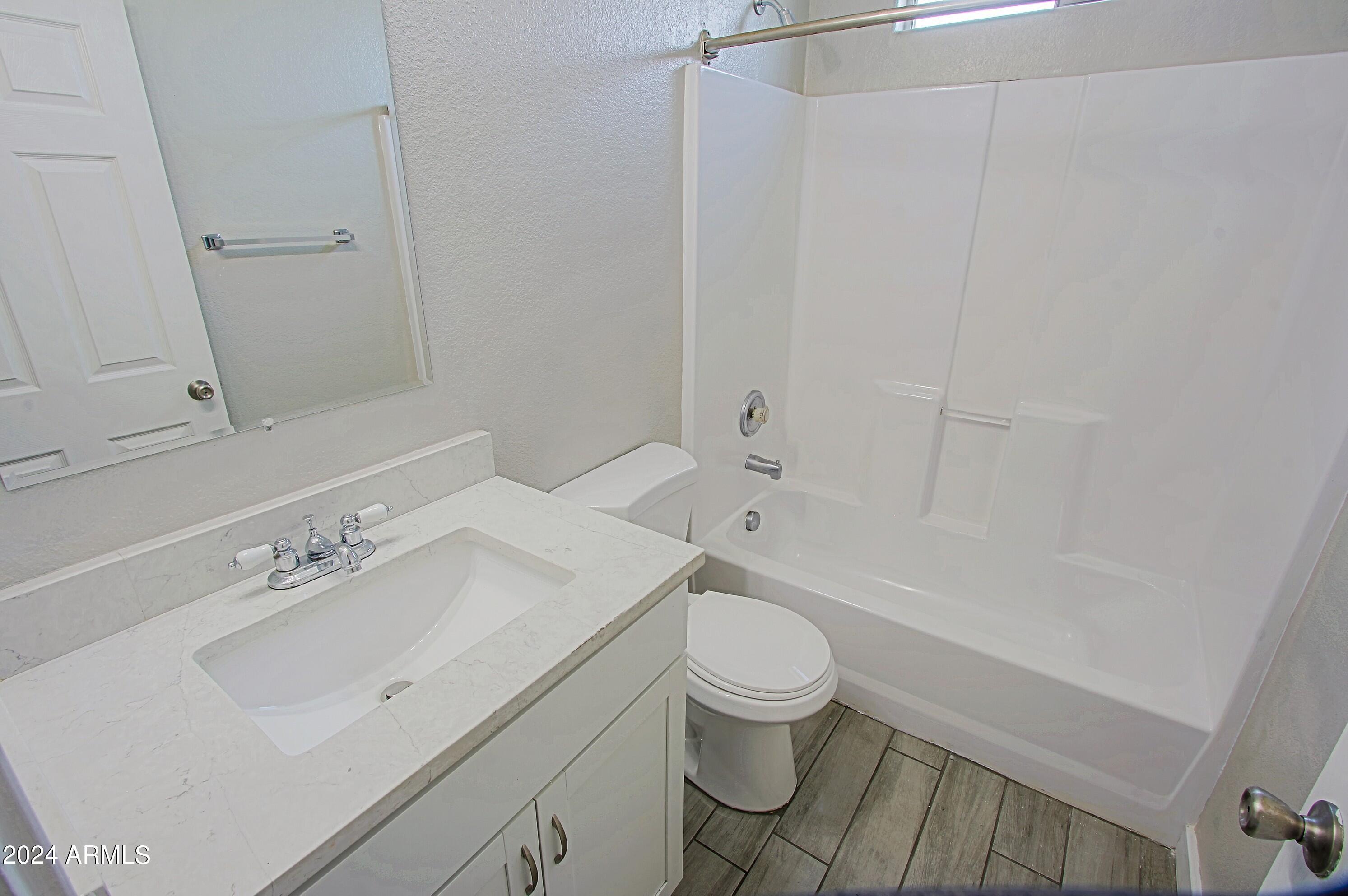 1614 West Purdue Avenue, Unit 202 Phoenix, AZ 85021 - Photo 7 of 8 a bathroom with a sink toilet and shower