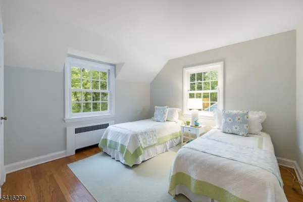 a bedroom with two beds and a window